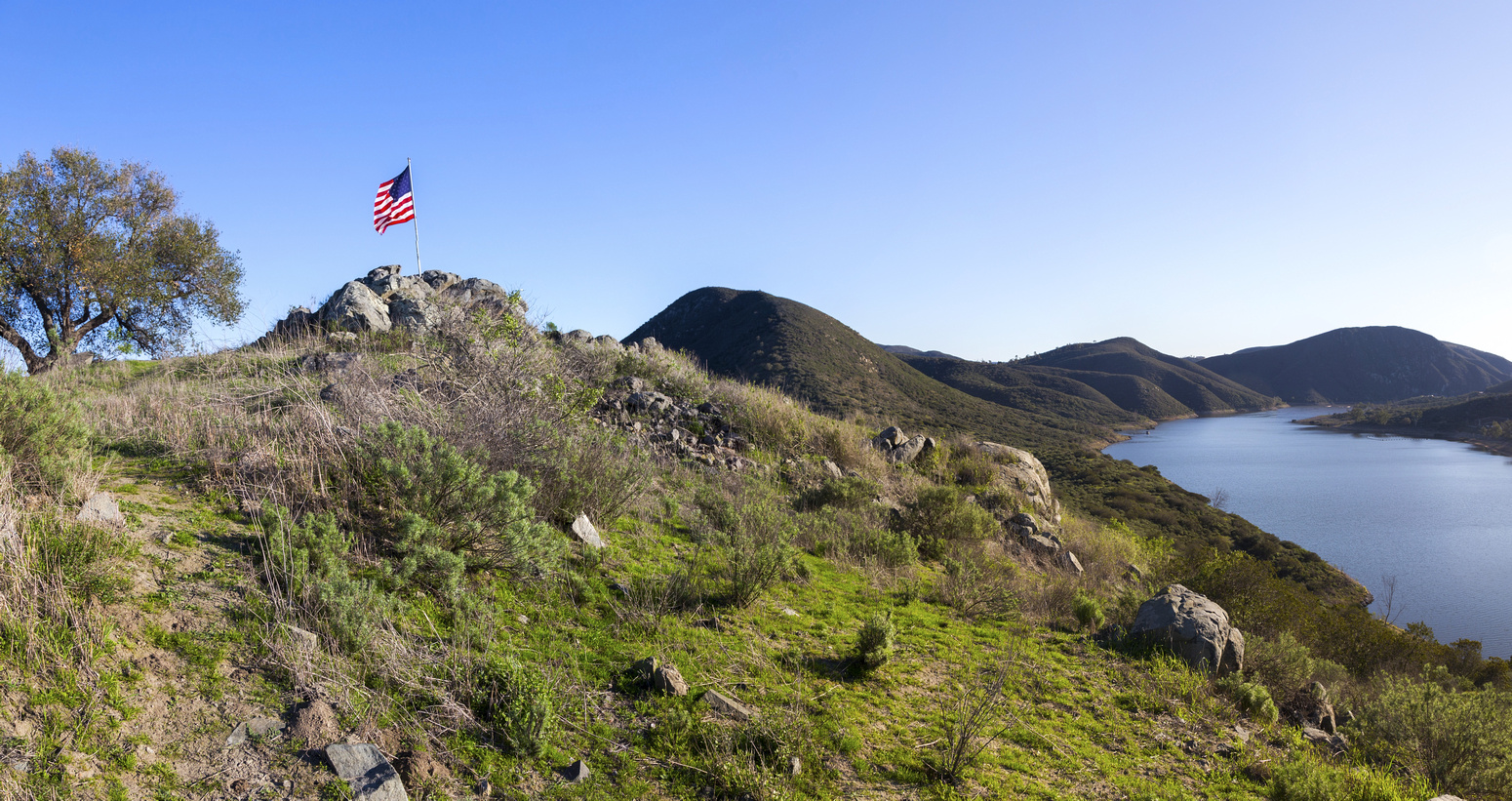 Fletcher Point with American Flag and Panoramic View down Del Dios Gorge.  Rough trail from S4 follows length of lake shore center right