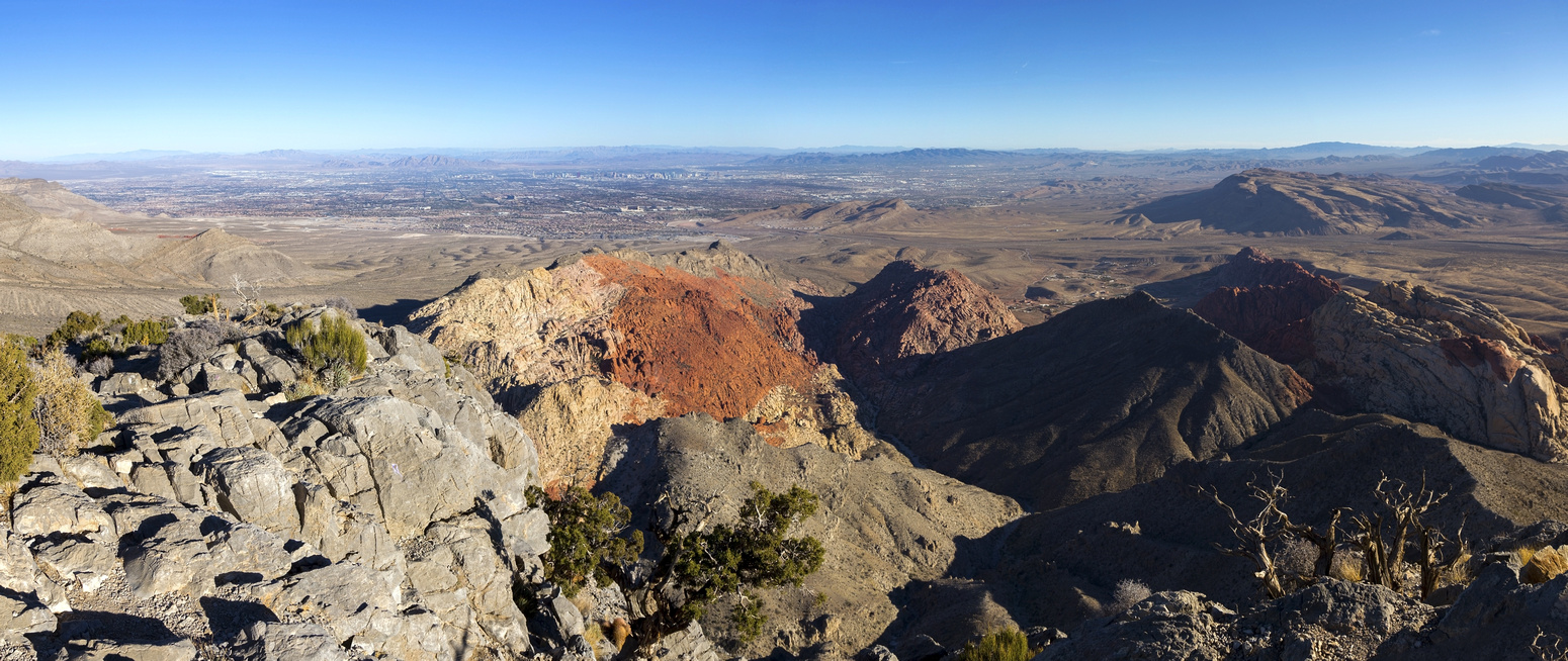 Summit Panorama with multi-colored rock layers and distant Las Vegas valley on Skyline